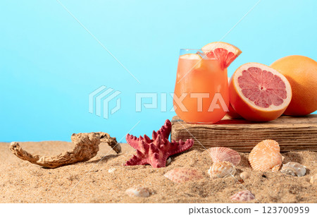 Grapefruit cocktail with ice on a old wooden board. 123700959