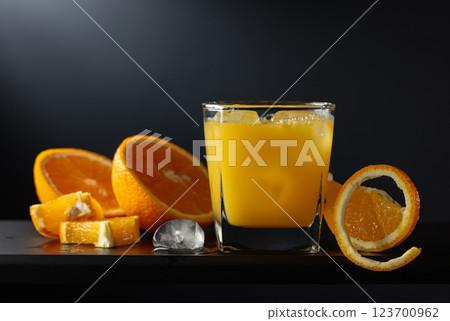 Glass of orange juice with ice on a black background. Glass of orange juice with ice on a black background. 123700962