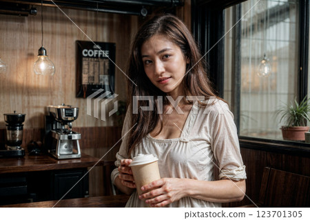 young woman drinking coffee in a cafe young woman drinking coffee in a cafe 123701305