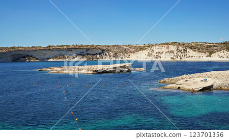 Malta coastline glimmers with azure sea. Malta environment merging rocky shores, Malta perspective inviting travelers seeking breezy vantage Malta coastline glimmers with azure sea. Malta environment merging rocky shores, Malta perspective inviting travelers seeking breezy vantage 123701356