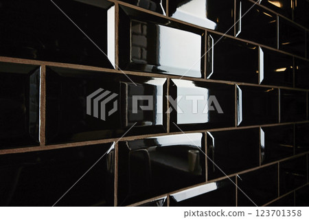 Glossy black surface offers dramatic reflection that amplifies spatial allure, reflection intensifying mood in high-end interiors 123701358