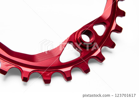 Close up of a red oval bicycle chainring against white isolated background. Professional bicycle part. 123701617