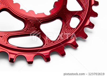Close up of a red oval bicycle chainring against white isolated background. Professional bicycle part. 123701619