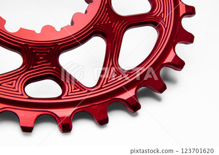 Close up of a red oval bicycle chainring against white isolated background. Professional bicycle part. Close up of a red oval bicycle chainring against white isolated background. Professional bicycle part. 123701620