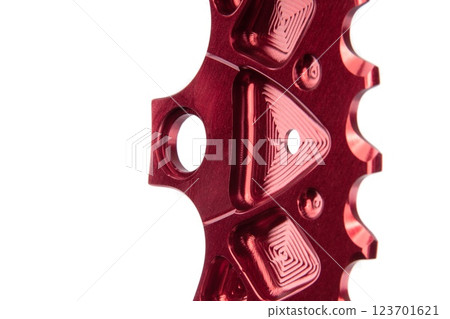 Close up of a red oval bicycle chainring against white isolated background. Professional bicycle part. Close up of a red oval bicycle chainring against white isolated background. Professional bicycle part. 123701621