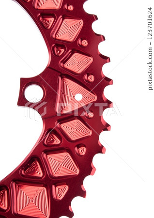 Close up of a red oval bicycle chainring against white isolated background. Professional bicycle part. 123701624
