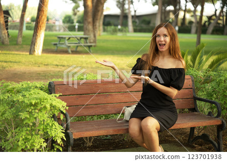 Woman in black dress posing in park during sunset Woman in black dress posing in park during sunset 123701938