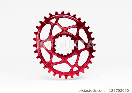 Red oval bicycle chainring against white isolated background, floating above the surface. Professional bicycle part. 123702090