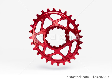 Red oval bicycle chainring against white isolated background, floating above the surface. Professional bicycle part. 123702093