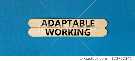 Adaptable working symbol. Concept words Adaptable working on beautiful wooden stick. Beautiful blue paper background. Business Adaptable working concept. Copy space. Adaptable working symbol. Concept words Adaptable working on beautiful wooden stick. Beautiful blue paper background. Business Adaptable working concept. Copy space. 123702345
