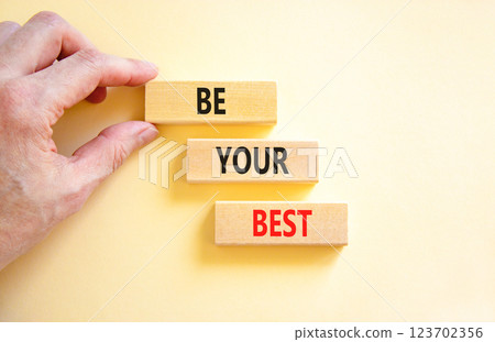 Motivational be your best symbol. Concept words Be your best on beautiful wooden blocks. Beautiful white background. Businessman hand. Business motivational be your best concept. Copy space. Motivational be your best symbol. Concept words Be your best on beautiful wooden blocks. Beautiful white background. Businessman hand. Business motivational be your best concept. Copy space. 123702356