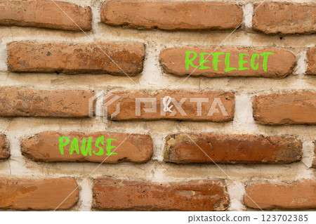 Pause and reflect symbol. Concept words Pause and reflect on beautiful brown brick wall. Beautiful brown brick wall background. Business motivational lifestyle pause and reflect concept. Copy space. Pause and reflect symbol. Concept words Pause and reflect on beautiful brown brick wall. Beautiful brown brick wall background. Business motivational lifestyle pause and reflect concept. Copy space. 123702385