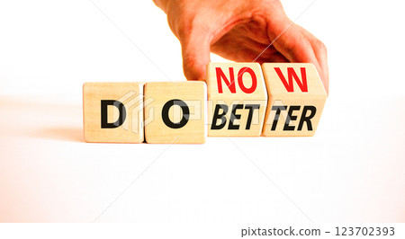 Do better and now symbol. Concept words Do better Do now on wooden block. Beautiful white table white background. Businessman hand. Business do better and now concept. Copy space. Do better and now symbol. Concept words Do better Do now on wooden block. Beautiful white table white background. Businessman hand. Business do better and now concept. Copy space. 123702393