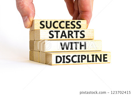 Success starts with discipline symbol. Concept words Success starts with discipline on beautiful wooden blocks. Beautiful white background. Business success starts with discipline concept. Copy space Success starts with discipline symbol. Concept words Success starts with discipline on beautiful wooden blocks. Beautiful white background. Business success starts with discipline concept. Copy space 123702415