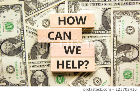 How can we help symbol. Concept words How can we help on beautiful wooden blocks. Dollar bills. Beautiful background from dollar bills. Business and how can we help concept. Copy space. How can we help symbol. Concept words How can we help on beautiful wooden blocks. Dollar bills. Beautiful background from dollar bills. Business and how can we help concept. Copy space. 123702416