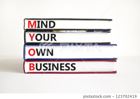 MYOB mind your own business symbol. Concept word MYOB Mind Your Own Business on beautiful books. Beautiful white background. Business MYOB mind your own business concept. Copy space. 123702419