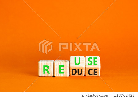 Reuse or reduce symbol. Concept words Reuse Reduce on wooden block. Beautiful orange table orange background. Business reuse or reduce concept. Copy space. Reuse or reduce symbol. Concept words Reuse Reduce on wooden block. Beautiful orange table orange background. Business reuse or reduce concept. Copy space. 123702425