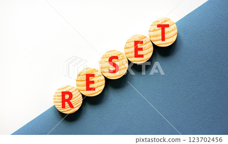 Reset symbol. Concept word Reset on beautiful wooden circles. Beautiful white and blue background. Business lifestyle reset concept. Copy space. 123702456
