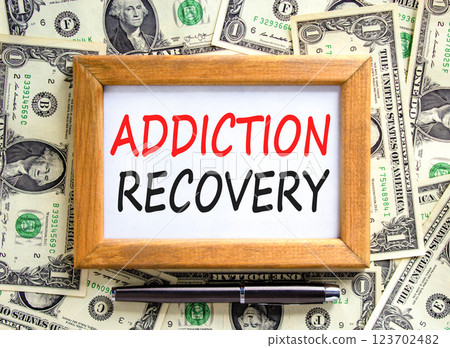 Addiction recovery symbol. Concept words Addiction recovery on beautiful wooden picture frame. Dollar bills. Beautiful background from dollar bills. Psychology addiction recovery concept. Copy space. Addiction recovery symbol. Concept words Addiction recovery on beautiful wooden picture frame. Dollar bills. Beautiful background from dollar bills. Psychology addiction recovery concept. Copy space. 123702482