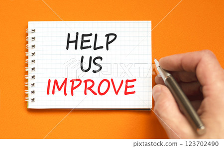Help us improve symbol. Concept words Help us improve on beautiful white note. Beautiful orange background. Black pen. Businessman hand. Business motivational help us improve concept. Copy space. Help us improve symbol. Concept words Help us improve on beautiful white note. Beautiful orange background. Black pen. Businessman hand. Business motivational help us improve concept. Copy space. 123702490