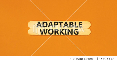 Adaptable working symbol. Concept words Adaptable working on beautiful wooden stick. Beautiful orange paper background. Business Adaptable working concept. Copy space. 123703348