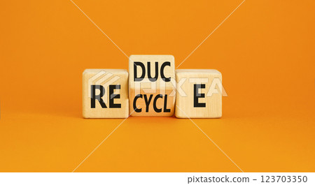 Reduce or recycle symbol. Concept words Reduce Recycle on wooden block. Beautiful orange table orange background. Business reduce or recycle concept. Copy space. 123703350