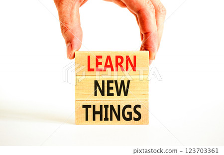 Learn new things symbol. Concept words Learn new things on beautiful wooden blocks. Beautiful white background. Businessman hand. Business motivational learn new things concept. Copy space. Learn new things symbol. Concept words Learn new things on beautiful wooden blocks. Beautiful white background. Businessman hand. Business motivational learn new things concept. Copy space. 123703361