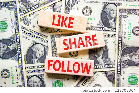 Like share follow symbol. Concept words Like Share Follow on beautiful wooden blocks. Dollar bills. Beautiful background from dollar bills. Business like share follow concept. Copy space. 123703364
