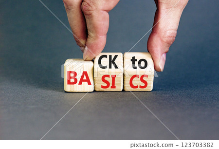 Back to basics symbol. Concept words Back to basics on wooden block. Beautiful grey table grey background. Businessman hand. Business back to basics concept. Copy space. Back to basics symbol. Concept words Back to basics on wooden block. Beautiful grey table grey background. Businessman hand. Business back to basics concept. Copy space. 123703382