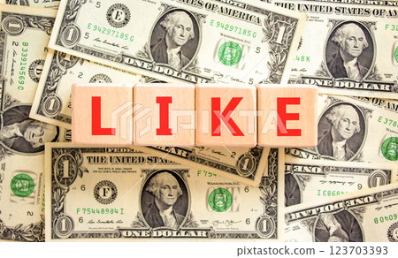 Like symbol. Concept word Like on beautiful wooden blocks. Dollar bills. Beautiful background from dollar bills. Business, lifestyle, support and like concept. Copy space. 123703393