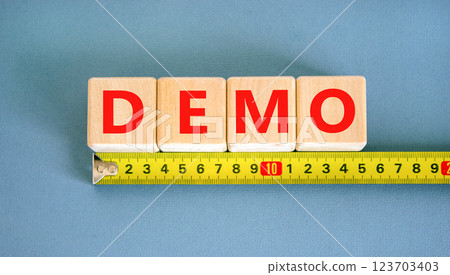 Demo symbol. Concept word Demo on beautiful wooden blocks. Beautiful yellow ruler. Beautiful blue table blue background. Business and demo concept. Copy space. 123703403