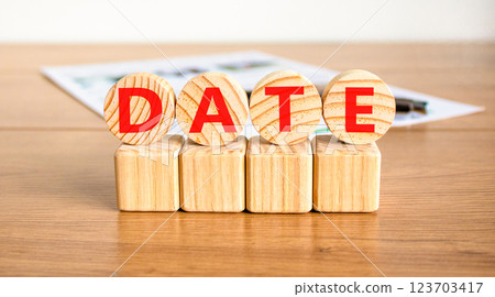 Date symbol. Concept word Date on beautiful wooden circles on wooden blocks. Beautiful wooden table white background. Business and date concept. Copy space. 123703417
