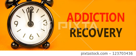 Addiction recovery symbol. Concept words Addiction recovery on beautiful orange paper. Black alarm clock. Beautiful orange paper background. Psychology addiction recovery concept. Copy space. Addiction recovery symbol. Concept words Addiction recovery on beautiful orange paper. Black alarm clock. Beautiful orange paper background. Psychology addiction recovery concept. Copy space. 123703436