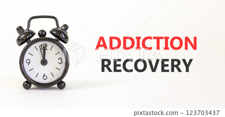Addiction recovery symbol. Concept words Addiction recovery on beautiful white paper. Black alarm clock. Beautiful white paper background. Psychology addiction recovery concept. Copy space. Addiction recovery symbol. Concept words Addiction recovery on beautiful white paper. Black alarm clock. Beautiful white paper background. Psychology addiction recovery concept. Copy space. 123703437