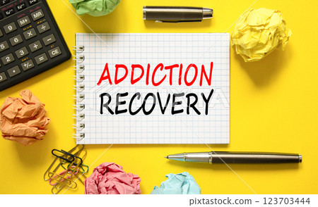 Addiction recovery symbol. Concept words Addiction recovery on beautiful white note. Black calculator. Colored paper. Beautiful yellow background. Psychology addiction recovery concept. Copy space. Addiction recovery symbol. Concept words Addiction recovery on beautiful white note. Black calculator. Colored paper. Beautiful yellow background. Psychology addiction recovery concept. Copy space. 123703444