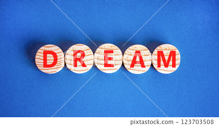 Dream symbol. Concept word Dream on beautiful wooden circles. Beautiful blue table blue background. Business lifestyle dream concept. Copy space. 123703508