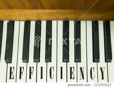 Efficiency symbol. Concept word Efficiency on beautiful keys of the old retro piano. Beautiful piano-keys background. Black and white keys of the piano. Business efficiency concept. Copy space. 123703522