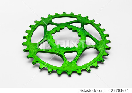 Green oval bicycle chainring against white isolated background. Professional bicycle part. Green oval bicycle chainring against white isolated background. Professional bicycle part. 123703685