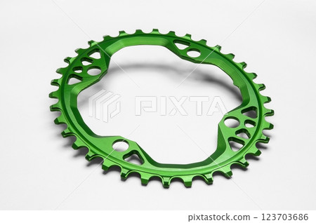 Green oval bicycle chainring against white isolated background. Professional bicycle part. 123703686