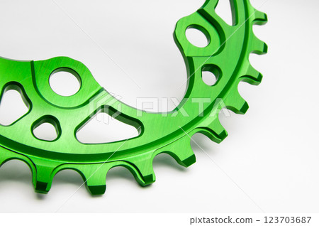 Close up of a green oval bicycle chainring against white isolated background. Professional bicycle part. Close up of a green oval bicycle chainring against white isolated background. Professional bicycle part. 123703687