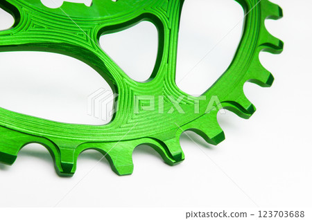 Close up of a green oval bicycle chainring against white isolated background. Professional bicycle part. Close up of a green oval bicycle chainring against white isolated background. Professional bicycle part. 123703688