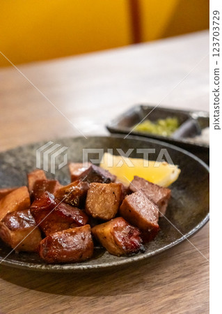 Grilled beef tongue served on plate with lemon 123703729