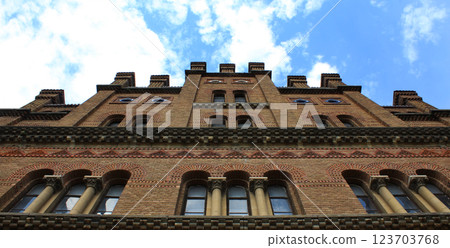 Facade Of Ancient Brick Castle Tower On Cloudy Sky Bottom View 123703768