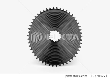 Black oval bicycle chainring against white isolated background, floating above the surface. Professional bicycle part. 123703771