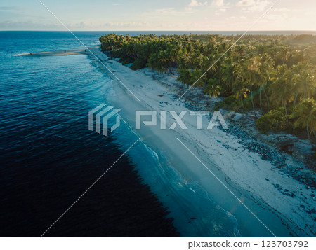 Maldives island with beach and sunrise or sunset. Aerial view of ocean coastline on Fuvahmulah island Maldives island with beach and sunrise or sunset. Aerial view of ocean coastline on Fuvahmulah island 123703792
