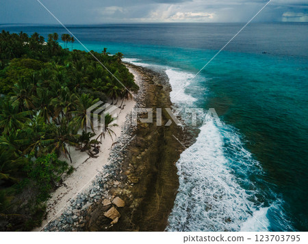 Drone view of ocean with waves and coastline on Fuvahmulah island 123703795