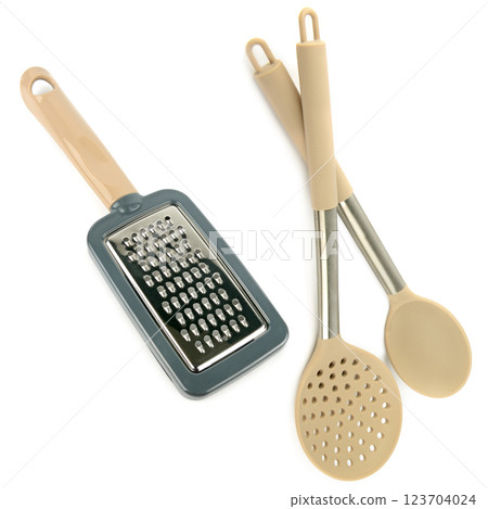 Grater, kitchen spoon and slotted spoon isolated on white. Collage. Grater, kitchen spoon and slotted spoon isolated on white. Collage. 123704024