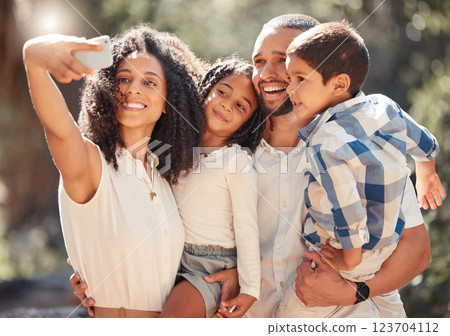 Family selfie with smartphone in a park or nature for outdoor summer wellness, hiking and happy holiday memory on mobile digital gallery. Mother portrait photo of children and father with lens flare Family selfie with smartphone in a park or nature for outdoor summer wellness, hiking and happy holiday memory on mobile digital gallery. Mother portrait photo of children and father with lens flare 123704112