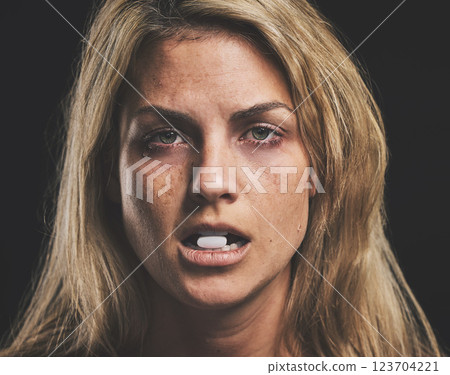 Woman, face and pill for drug in addiction for substance abuse to cure pain and suffering over black studio background. Portrait of female addict or model addicted to medical pills, help and rehab 123704221