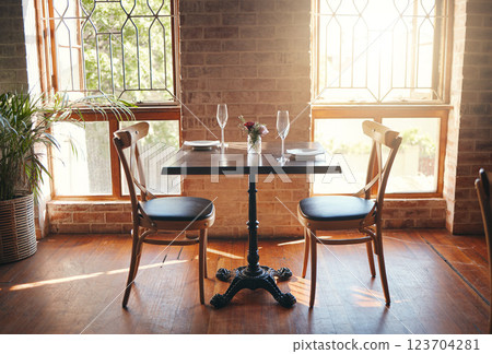 Empty room, glasses and table at a restaurant for a romantic date, celebration or luxury dinner. Wineglass for champagne, wine or alcohol beverage for a banquet, romance meal or elegant event. 123704281
